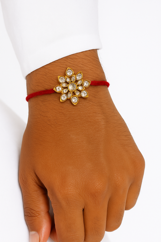 22K Gold Plated Lotus Leaf Kundan Rakhi with White Glass Stones & Red Thread
