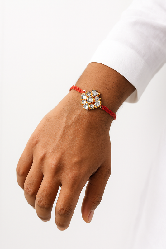 22K Gold Plated Flower Style Kundan Rakhi with White Glass & Shiny Stones Wrapped in Red Thread