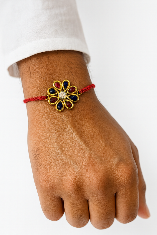 22K Gold Plated Kundan Rakhi with Maroon & Dark Purple Stones in Flower Design